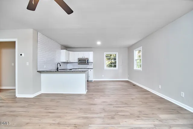 a view of kitchen with refrigerator and window