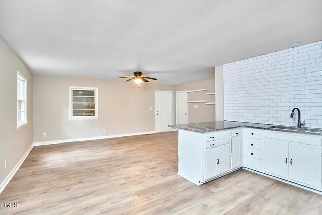 a view of a kitchen with granite countertop cabinets and wooden floor