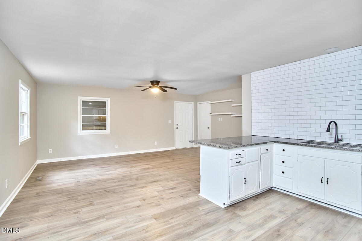 2128 Strebor Street Durham, NC 27705 - Photo 13 of 51 a view of a kitchen with granite countertop cabinets and wooden floor