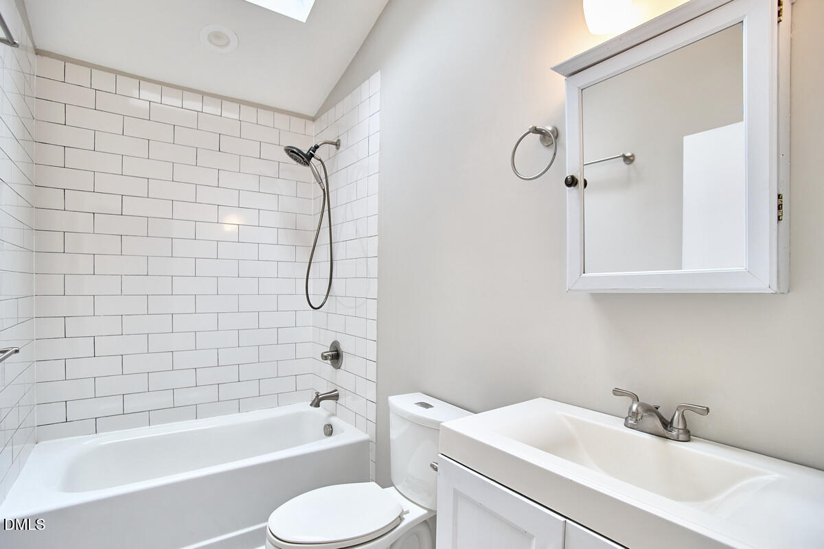2128 Strebor Street Durham, NC 27705 - Photo 18 of 51 a bathroom with a sink toilet and shower