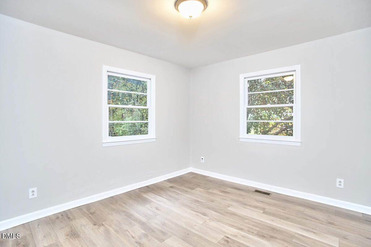 2128 Strebor Street Durham, NC 27705 - Photo 19 of 51 an empty room with wooden floor and windows