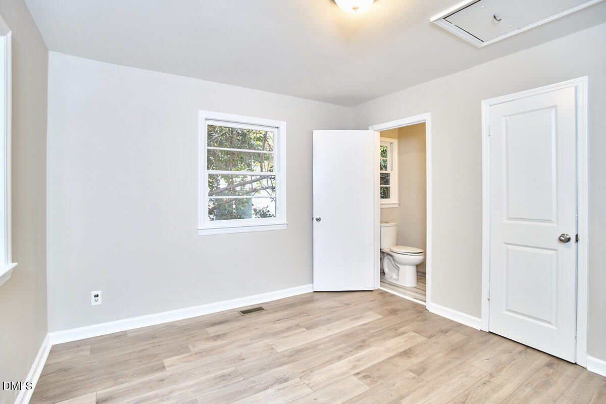 2128 Strebor Street Durham, NC 27705 - Photo 20 of 51 a view of an empty room with wooden floor and a window