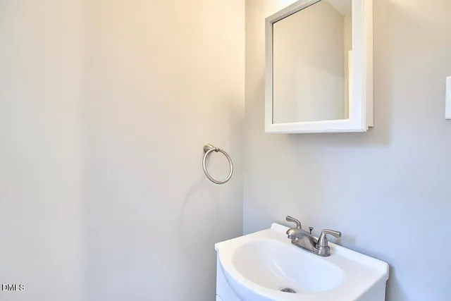 a bathroom with a sink a mirror and a window