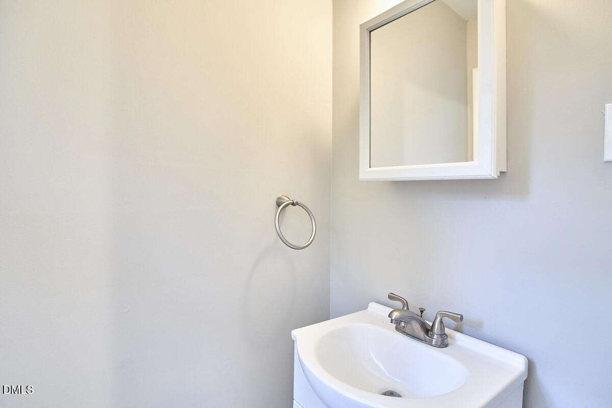2128 Strebor Street Durham, NC 27705 - Photo 21 of 51 a bathroom with a sink a mirror and a window