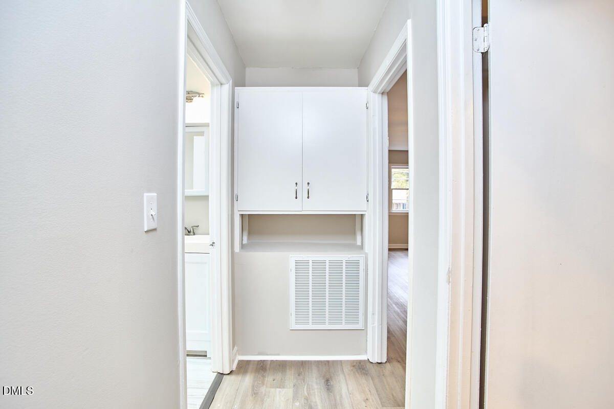 2128 Strebor Street Durham, NC 27705 - Photo 22 of 51 a view of a kitchen with white cabinets and a window