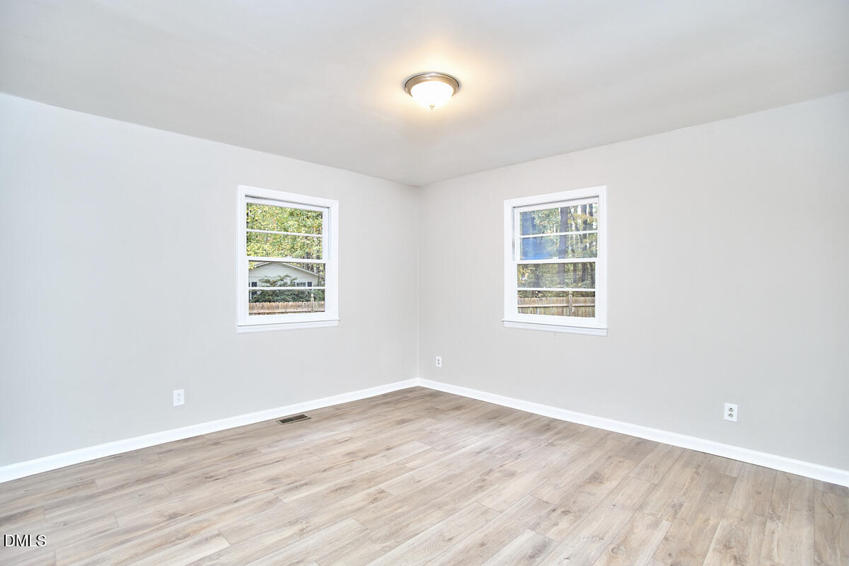 2128 Strebor Street Durham, NC 27705 - Photo 23 of 51 an empty room with wooden floor and windows