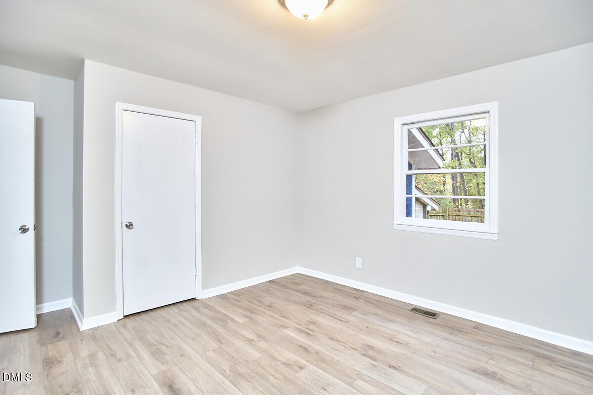 2128 Strebor Street Durham, NC 27705 - Photo 24 of 51 a view of an empty room with wooden floor and a window
