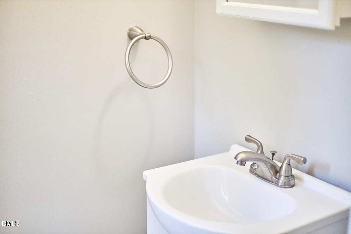2128 Strebor Street Durham, NC 27705 - Photo 37 of 51 a bathroom with a sink and a mirror