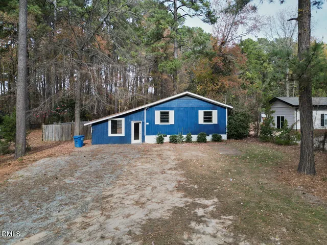 a house with trees in the background