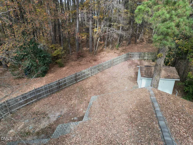 a view of a yard with large trees
