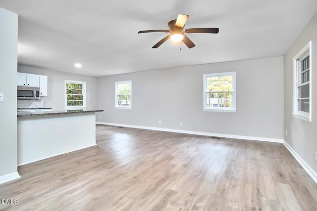wooden floor in an empty room with a window