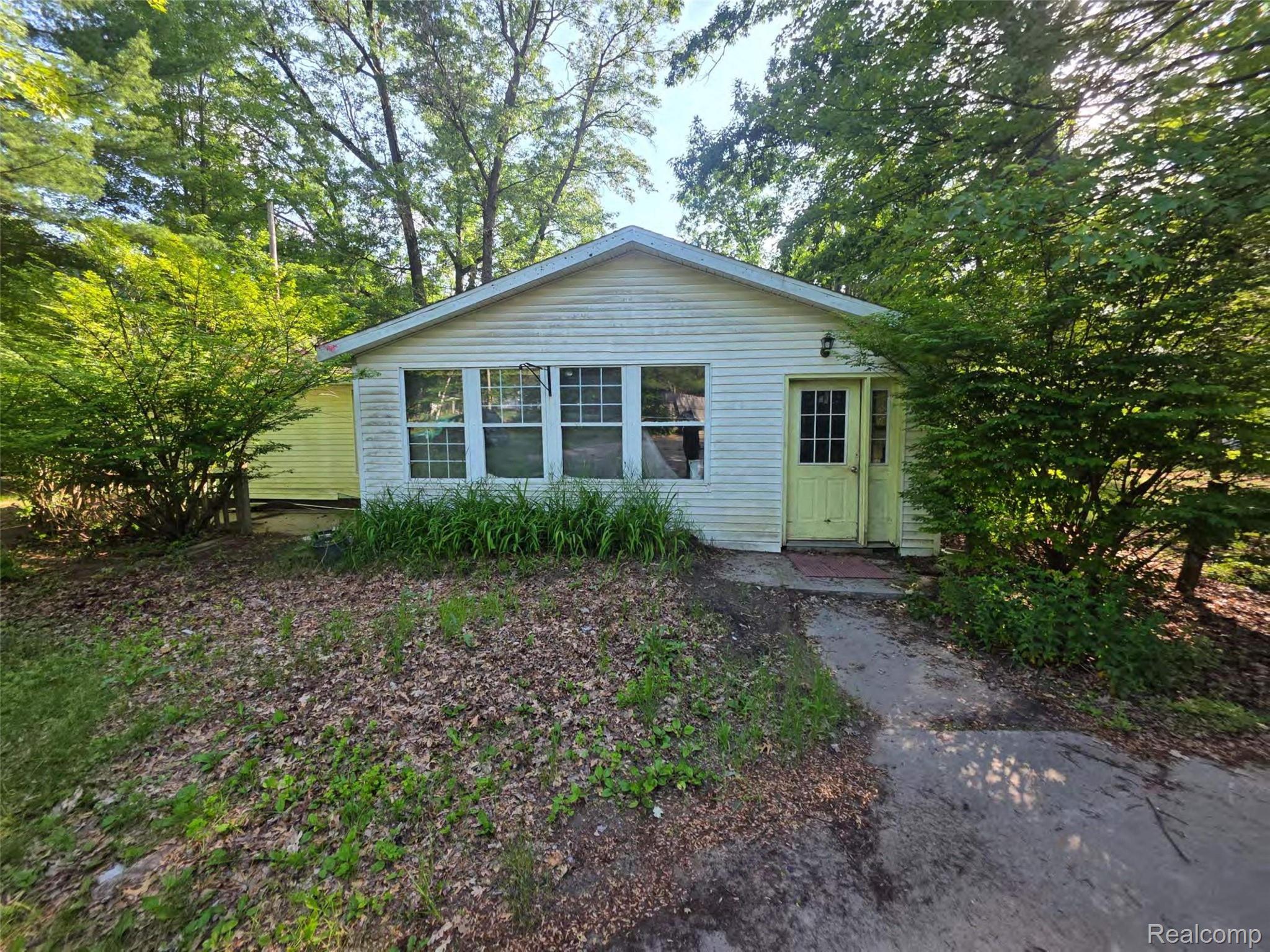 5420 Randy Drive Prescott, MI 48756 - Photo 1 of 31 Single-story residence featuring white siding and a prominent front entry with a yellow door