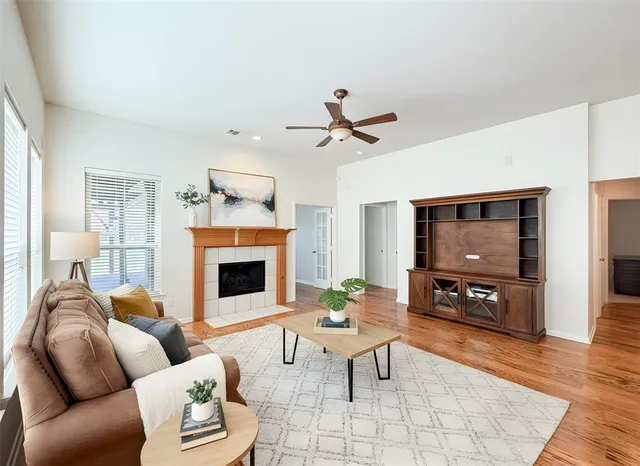 a living room with furniture a fireplace and a flat screen tv