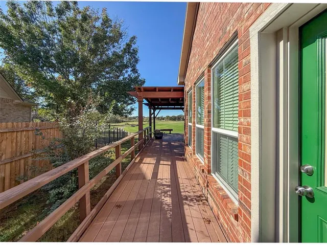 a view of balcony with wooden floor and bench in the balcony