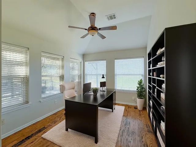 a dining room with furniture window and wooden floor