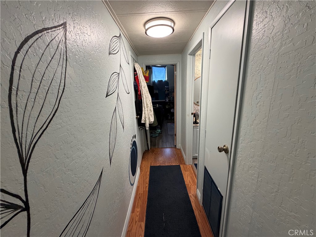 1550 Rimpau, Unit 71 Corona, CA 92881 - Photo 13 of 51 a view of a hallway with wooden floor and staircase