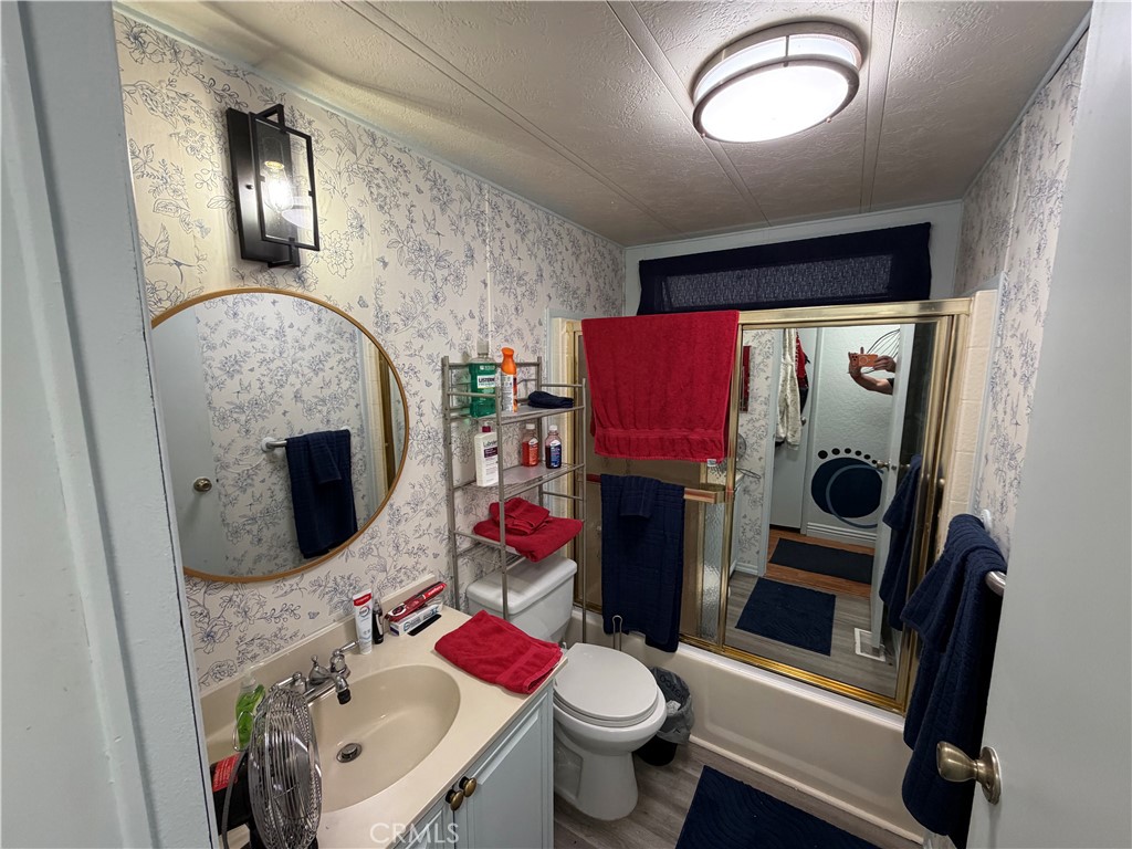 1550 Rimpau, Unit 71 Corona, CA 92881 - Photo 15 of 51 a bathroom with a sink toilet and mirror
