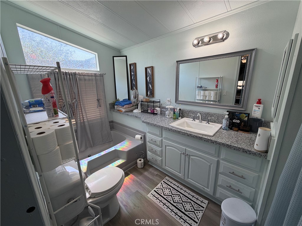 1550 Rimpau, Unit 71 Corona, CA 92881 - Photo 17 of 51 a bathroom with a sink mirror vanity and toilet
