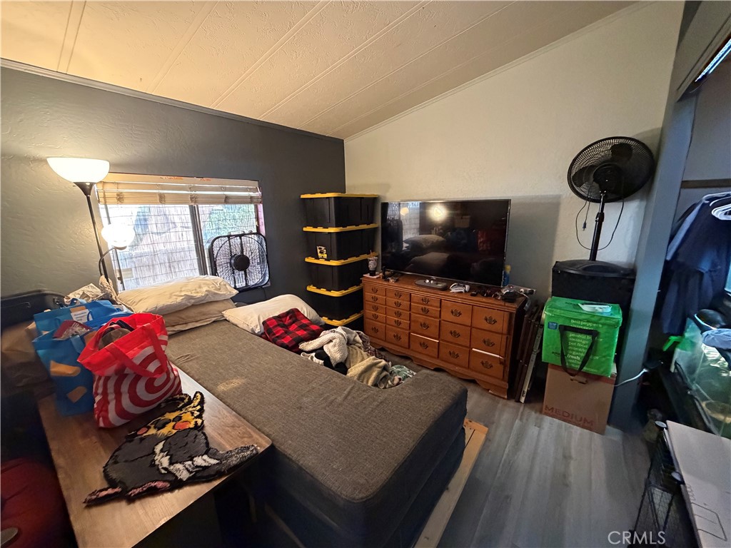1550 Rimpau, Unit 71 Corona, CA 92881 - Photo 19 of 51 a bedroom with furniture and a flat screen tv