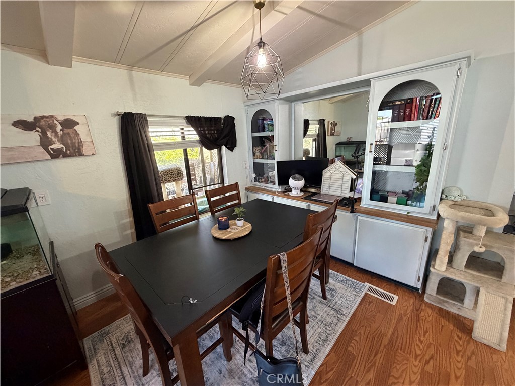 1550 Rimpau, Unit 71 Corona, CA 92881 - Photo 22 of 51 a view of a dining room with furniture window and wooden floor