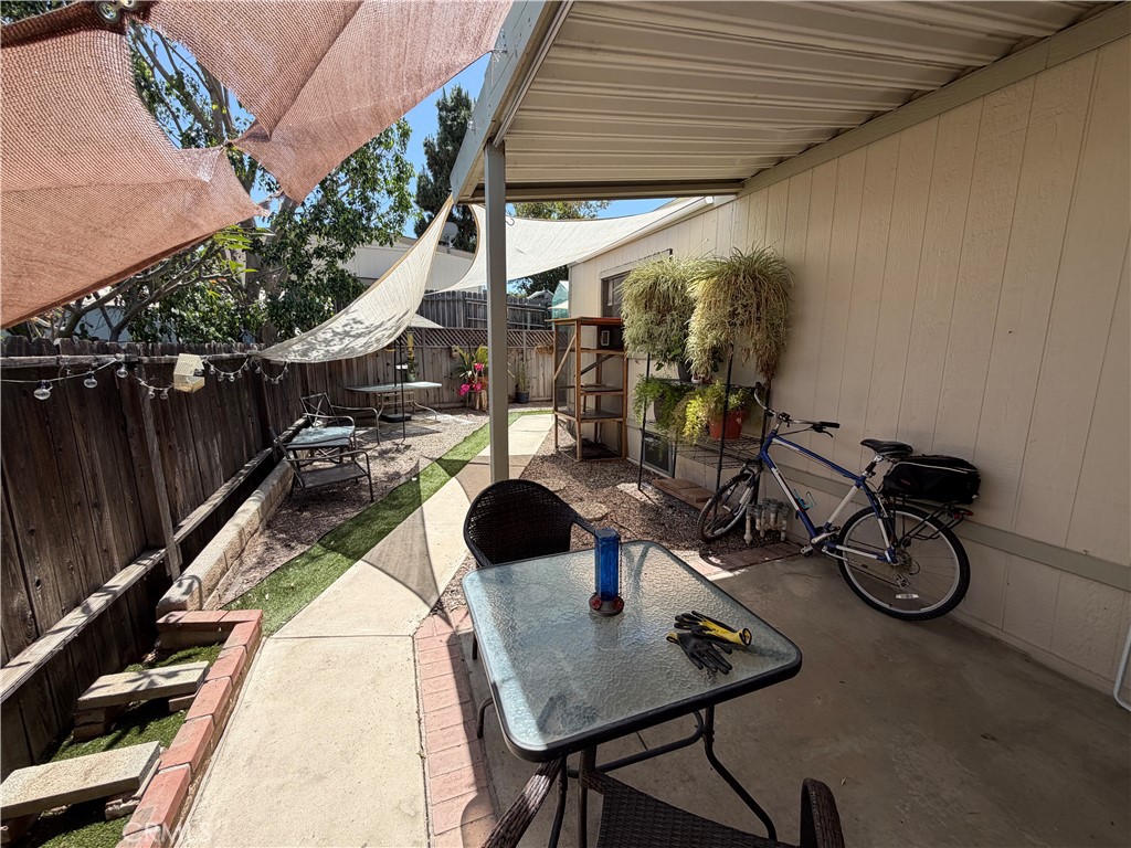 1550 Rimpau, Unit 71 Corona, CA 92881 - Photo 26 of 51 a view of a patio with table and chairs and potted plants