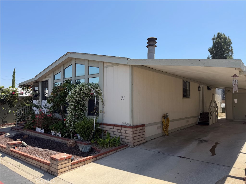 1550 Rimpau, Unit 71 Corona, CA 92881 - Photo 36 of 51 a front view of a house with yard