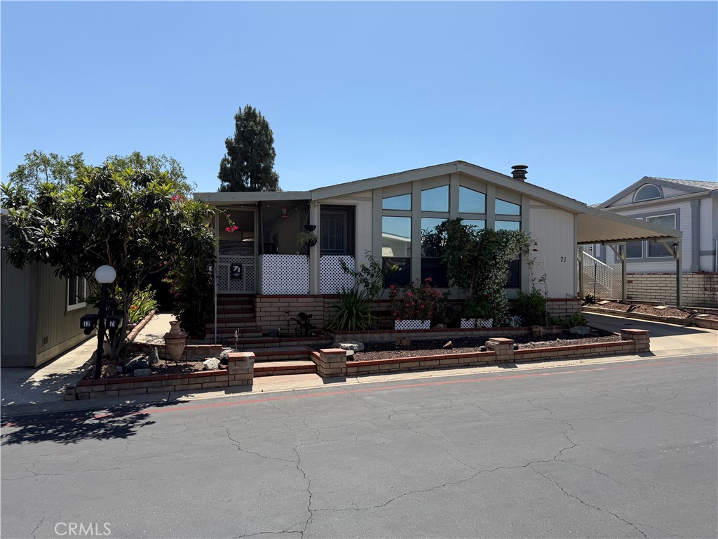 1550 Rimpau, Unit 71 Corona, CA 92881 - Photo 39 of 51 a front view of a house with a yard