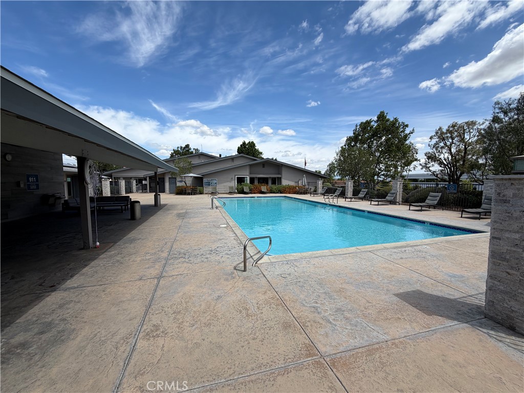 1550 Rimpau, Unit 71 Corona, CA 92881 - Photo 41 of 51 a swimming pool with outdoor seating and plants