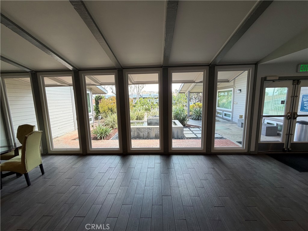 1550 Rimpau, Unit 71 Corona, CA 92881 - Photo 46 of 51 a view of an empty room with wooden floor and a window