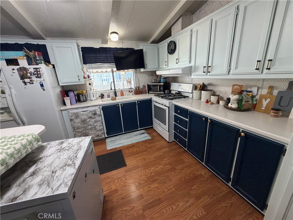 1550 Rimpau, Unit 71 Corona, CA 92881 - Photo 5 of 51 a kitchen with stainless steel appliances granite countertop a refrigerator sink and cabinets