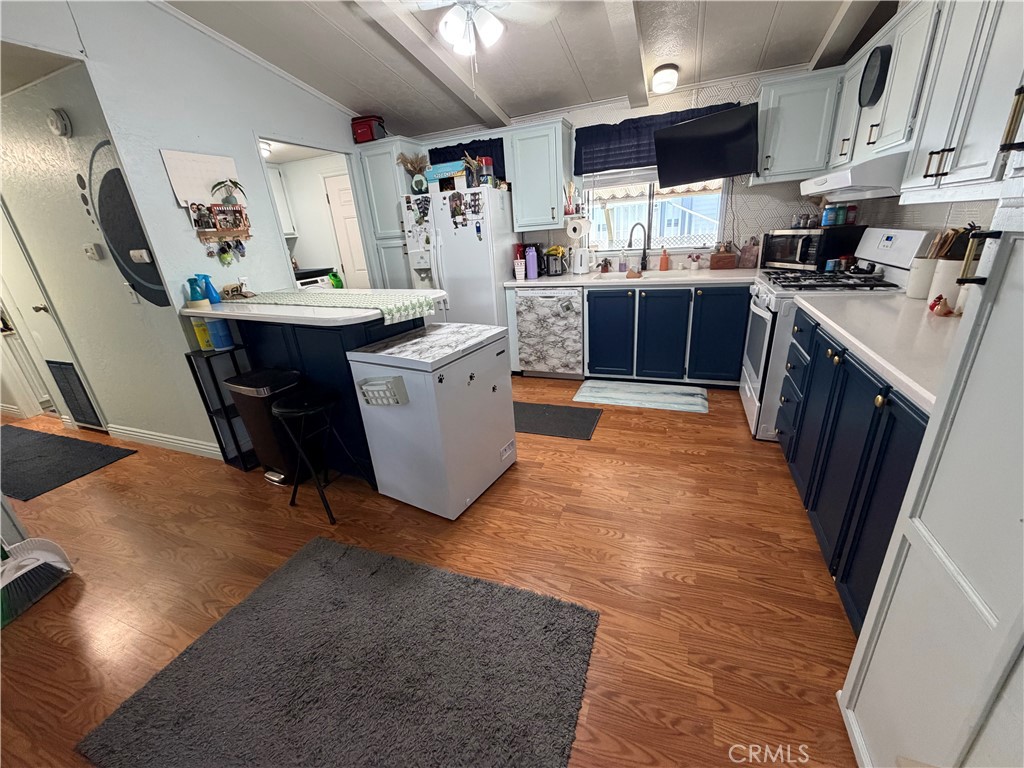 1550 Rimpau, Unit 71 Corona, CA 92881 - Photo 8 of 51 a kitchen with a sink a counter top space stainless steel appliances and a window