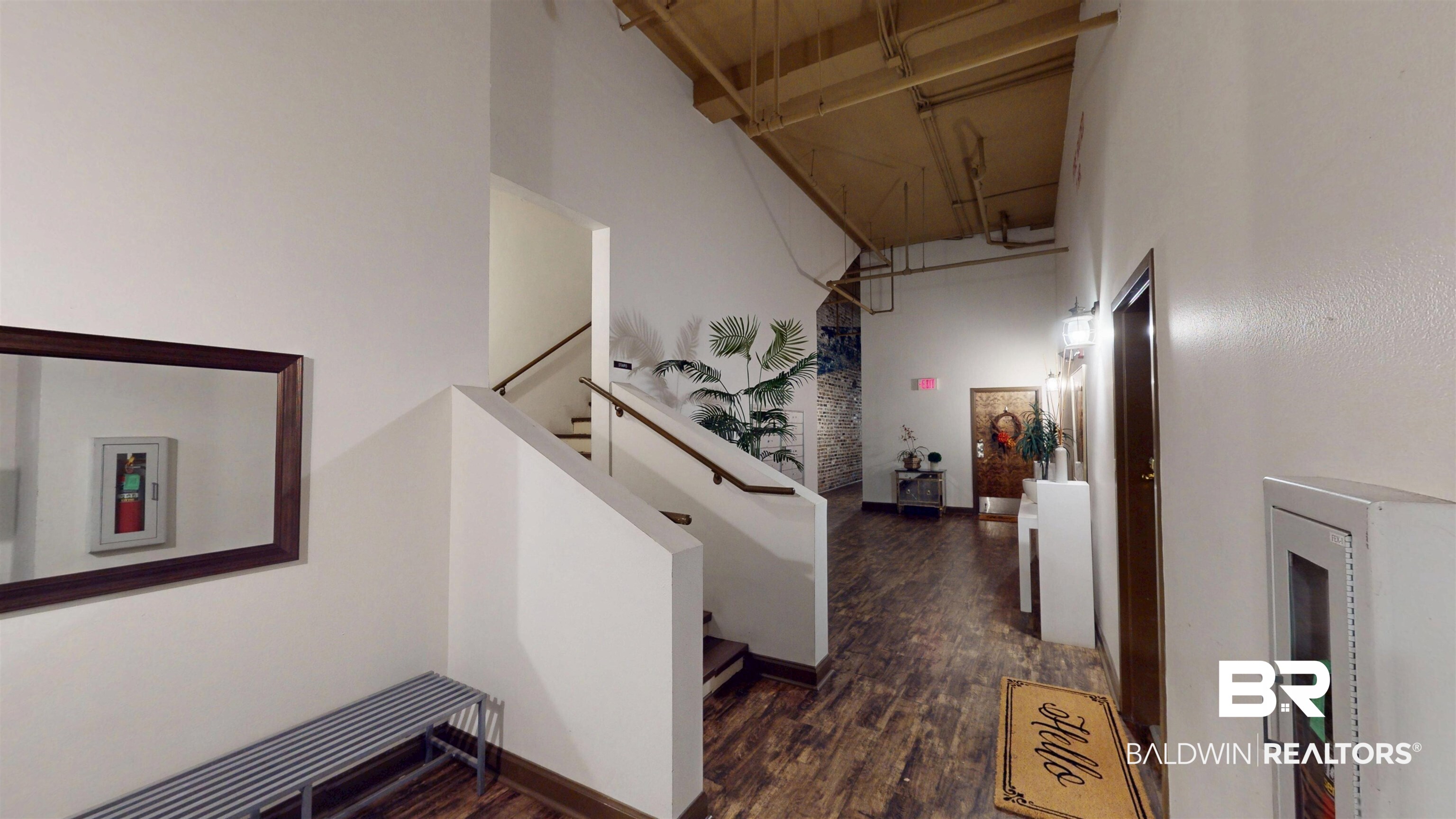 308 St Louis Street, Unit 101 Mobile, AL 36602 - Photo 13 of 30 Hall featuring a high ceiling and dark wood-style floors