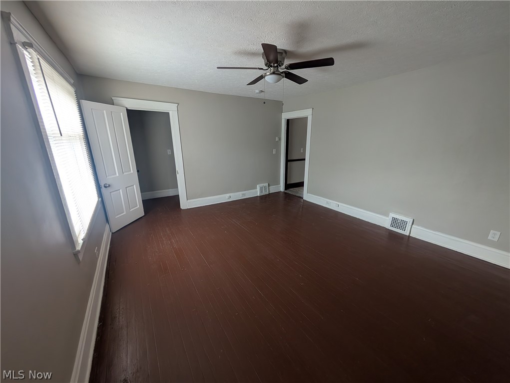 7515 Ottawa Road Cleveland, OH 44105 - Photo 10 of 21 Spacious room featuring rich wood-finish flooring, light gray wall paint, and white trim