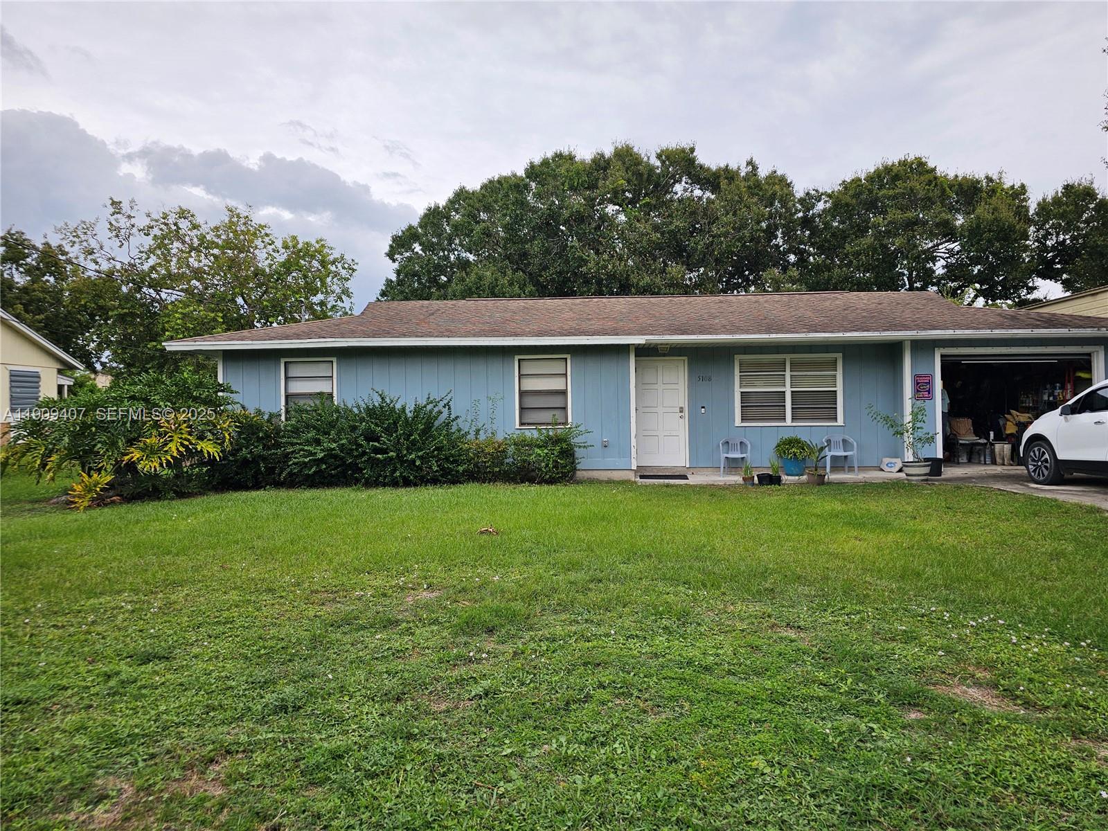 5108 Myrtle Drive Fort Pierce, FL 34982 - Photo 1 of 30 a view of a house with backyard and garden