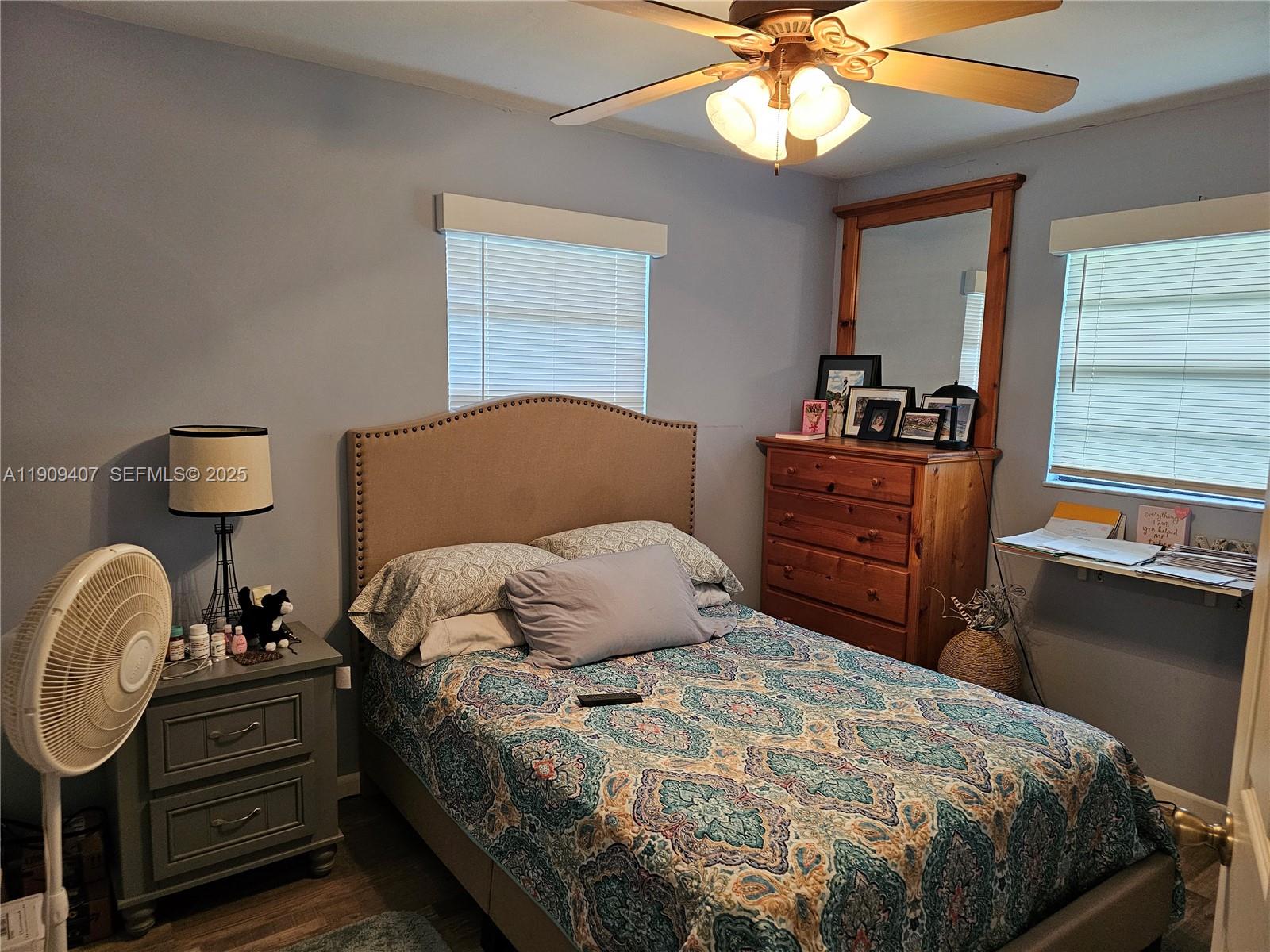 5108 Myrtle Drive Fort Pierce, FL 34982 - Photo 27 of 30 a bedroom with a bed and a chandelier