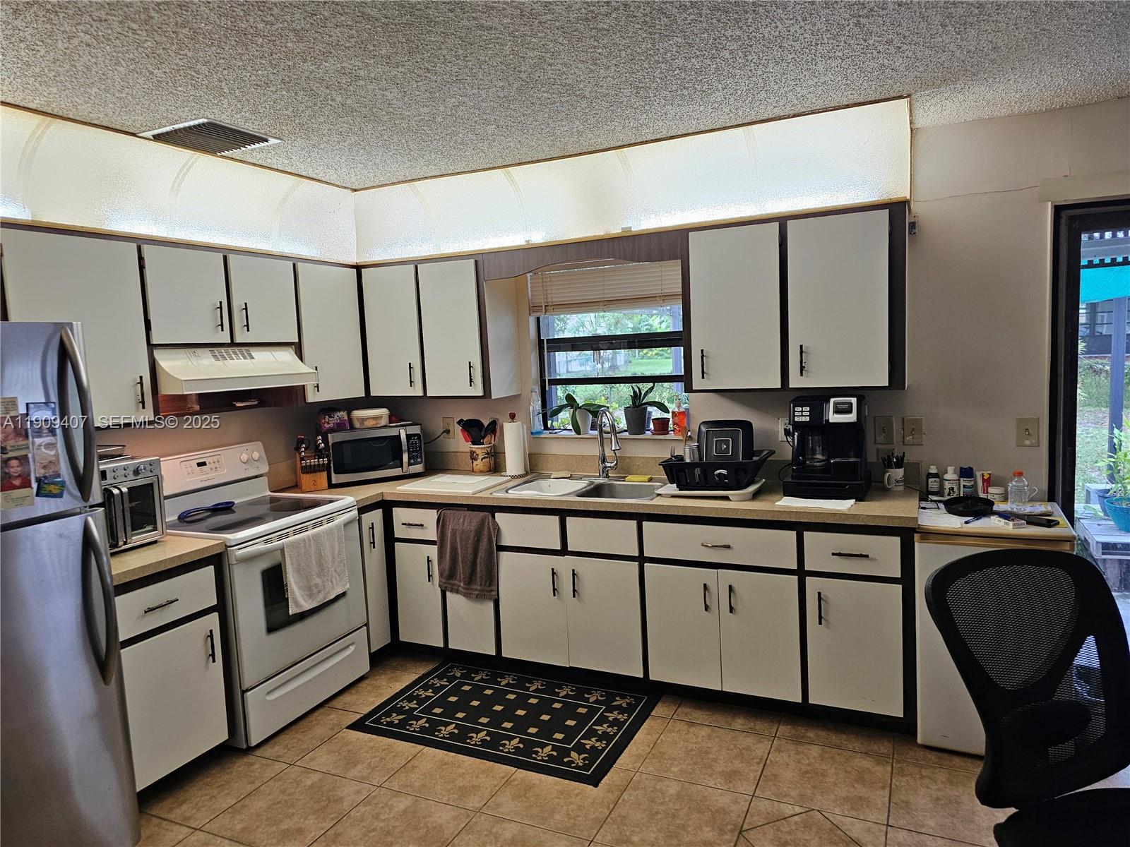 5108 Myrtle Drive Fort Pierce, FL 34982 - Photo 28 of 30 a kitchen with a sink stove and cabinets