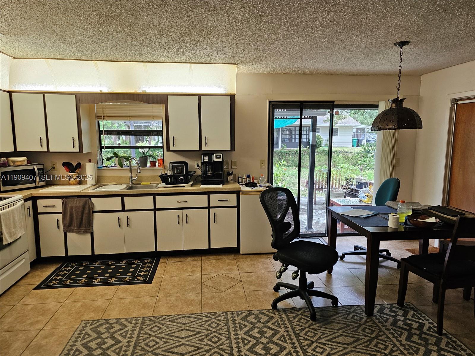 5108 Myrtle Drive Fort Pierce, FL 34982 - Photo 29 of 30 a kitchen with a table chairs and a stove