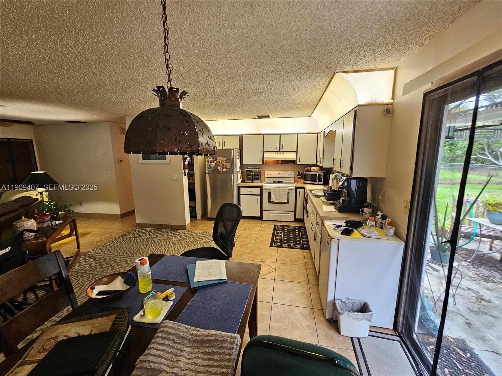 5108 Myrtle Drive Fort Pierce, FL 34982 - Photo 5 of 30 a workspace with furniture wooden floor and windows