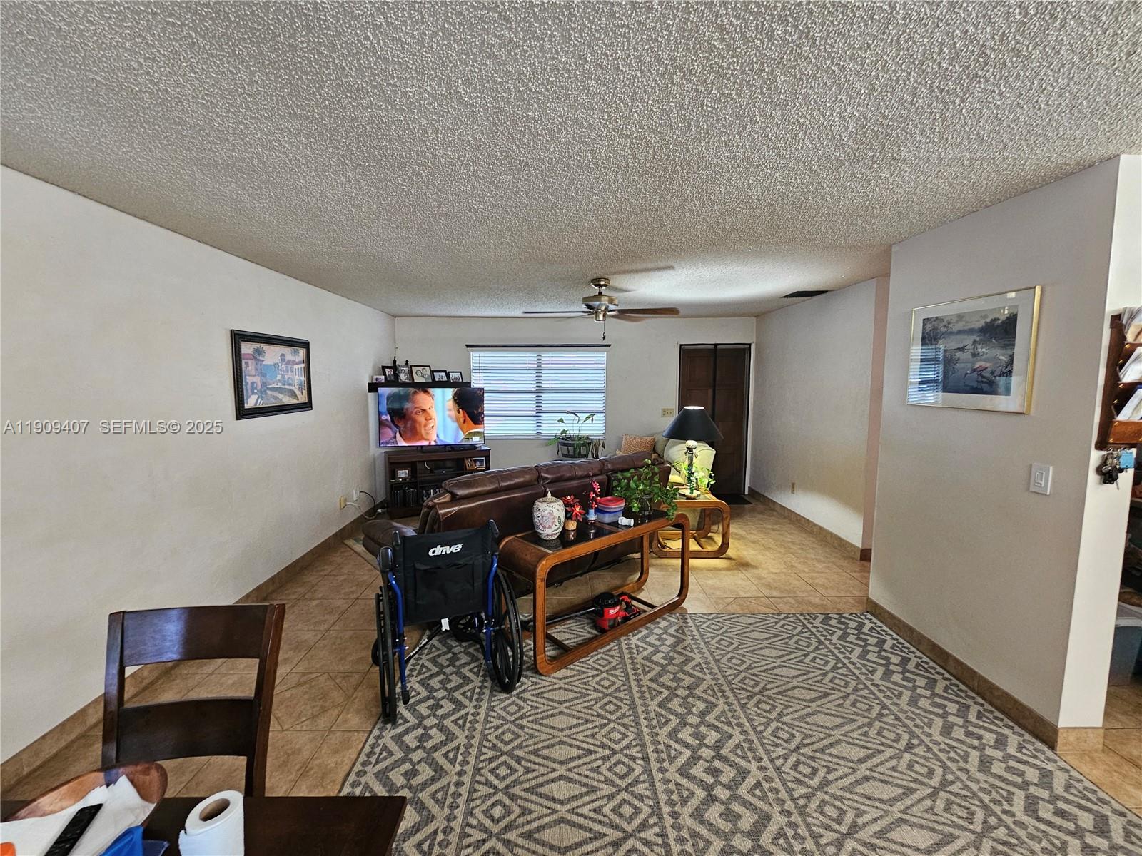 5108 Myrtle Drive Fort Pierce, FL 34982 - Photo 6 of 30 a living room with furniture and a flat screen tv
