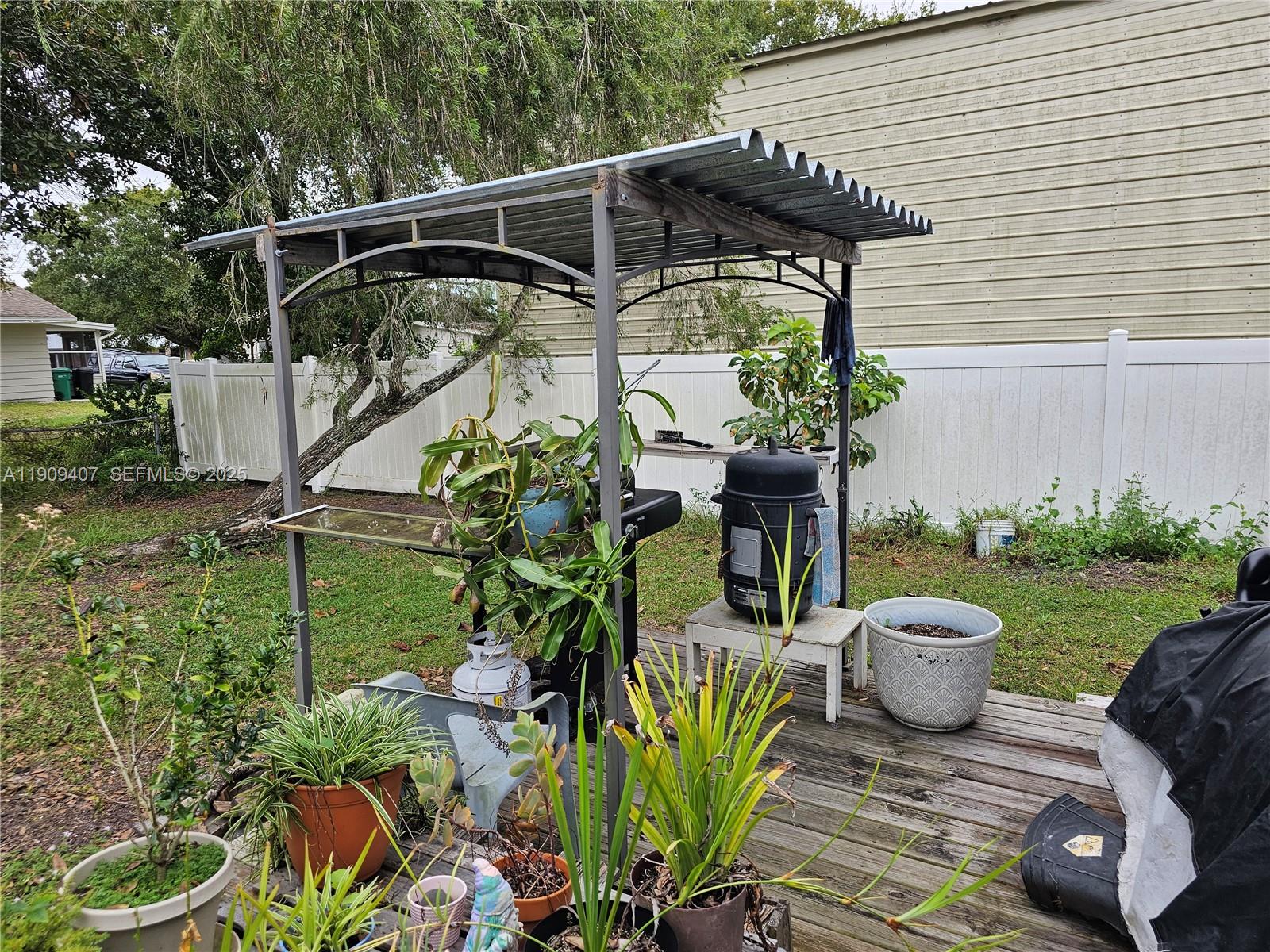 5108 Myrtle Drive Fort Pierce, FL 34982 - Photo 10 of 30 a view of a chair and table in backyard of the house