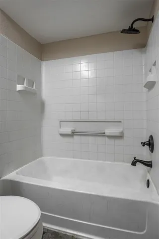 a bathroom with a bathtub and a toilet