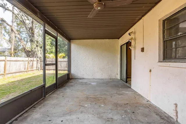 a view of backyard with wooden fence