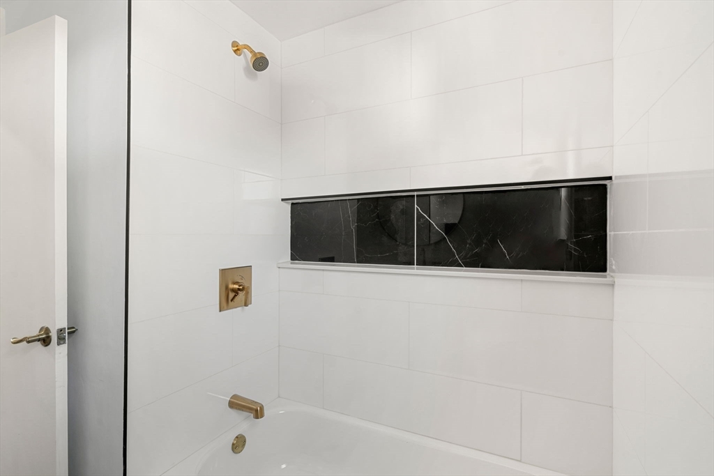 50 Bow Street Saugus, MA 01906 - Photo 11 of 37 a bathroom with a bathtub and a shower