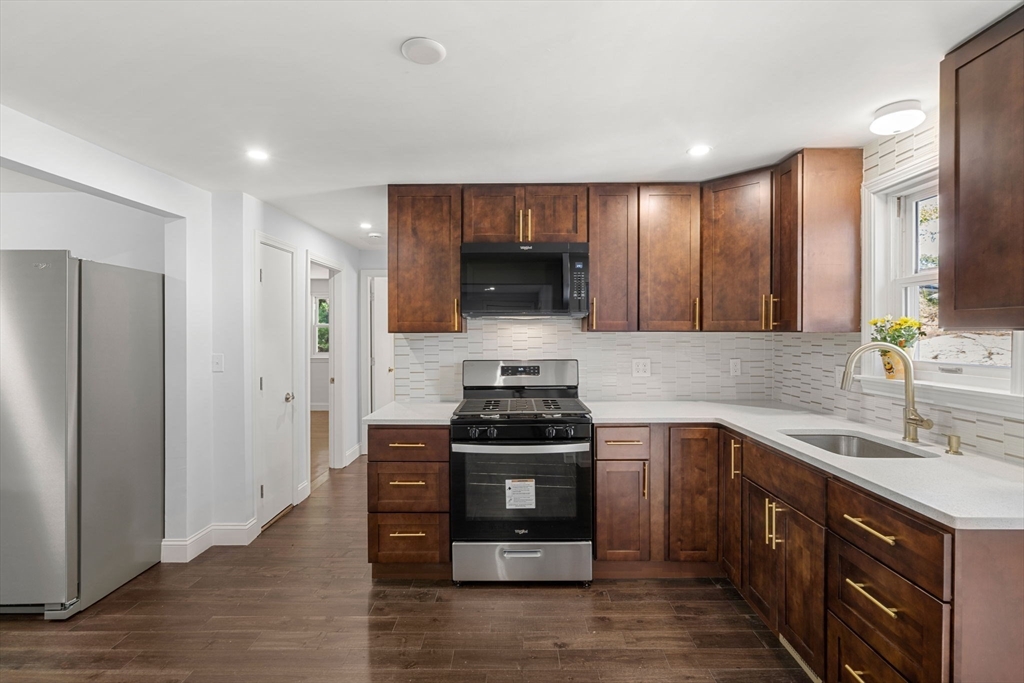 50 Bow Street Saugus, MA 01906 - Photo 12 of 37 a kitchen with stainless steel appliances granite countertop a stove and a sink