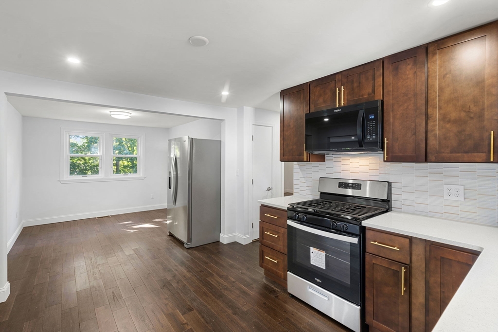 50 Bow Street Saugus, MA 01906 - Photo 15 of 37 a kitchen with stainless steel appliances granite countertop a stove a sink and a refrigerator
