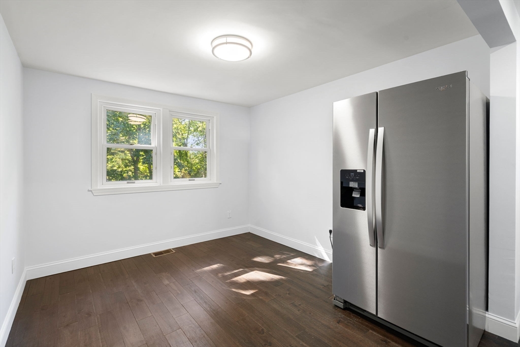 50 Bow Street Saugus, MA 01906 - Photo 16 of 37 an empty room with wooden floor cabinet and windows