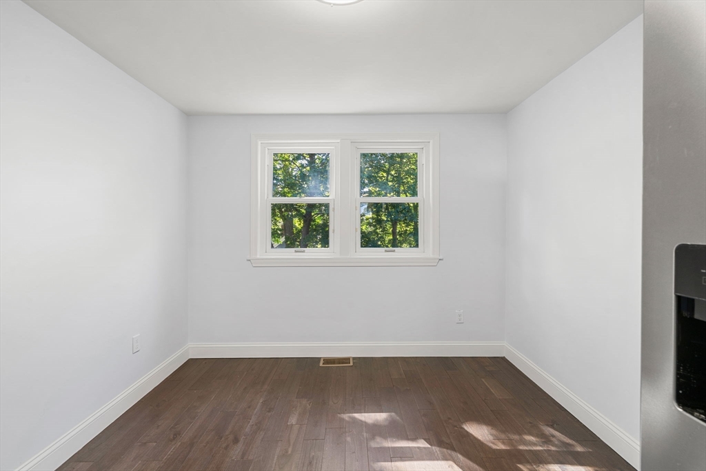 50 Bow Street Saugus, MA 01906 - Photo 17 of 37 an empty room with wooden floor and windows