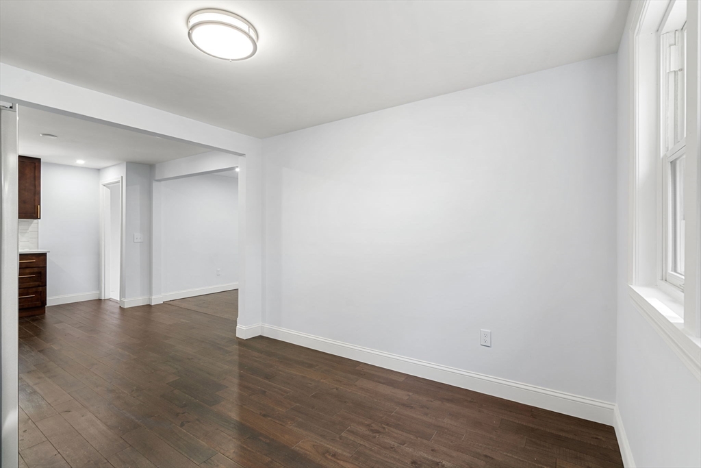 50 Bow Street Saugus, MA 01906 - Photo 18 of 37 an empty room with wooden floor and windows