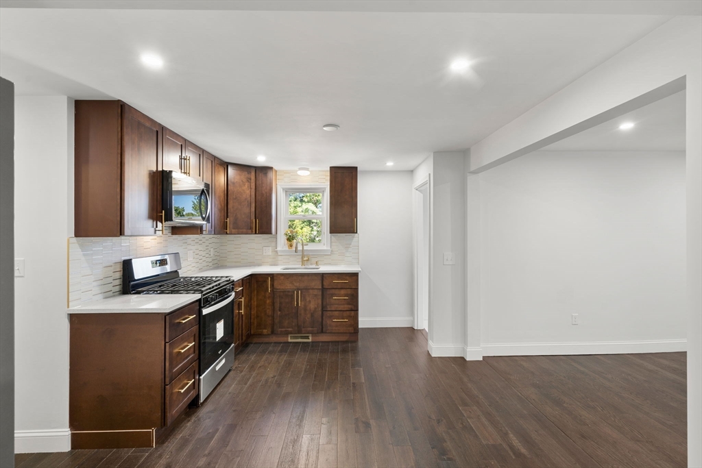 50 Bow Street Saugus, MA 01906 - Photo 19 of 37 a kitchen with granite countertop a sink cabinets and wooden floor