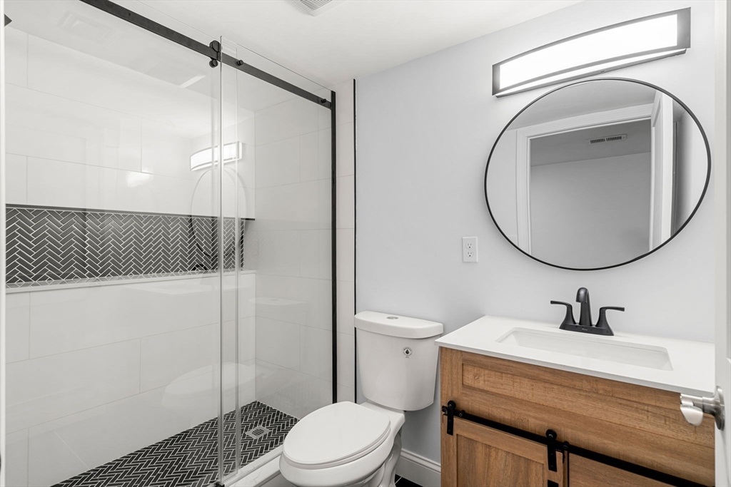 50 Bow Street Saugus, MA 01906 - Photo 24 of 37 a bathroom with a sink a toilet and a mirror